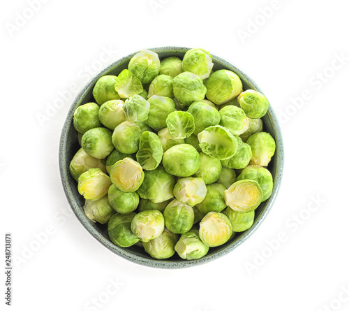 Bowl of fresh Brussels sprouts isolated on white, top view