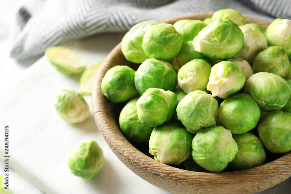 Bowl with fresh Brussels sprouts on table, closeup. Space for text Bowl with fresh Brussels sprouts on table, closeup. Space for text