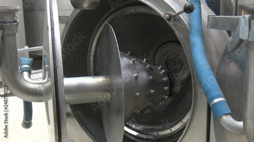 Chopping potatoes on a grater machine. Industrial workshop for the production of starch. Processing of potatoes. Production of starch photo