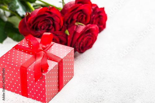 Red roses flower and present box on white. 