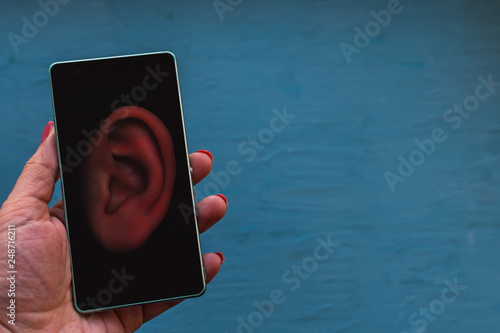 Cuadro en lienzo concept of wiretapping smartphones.ear on the phone screen