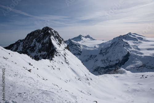 View of the Presena glacier at 3100 meters of altitude and the mountains around the Tonale Pass, during a winter sunny day. Tonale is a mountain pass between Lombardy and Trentino