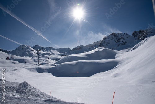 View of the mountains around the Tonale Pass from the Paradiso lodge during a winter sunny day. Tonale is a mountain pass between Lombardy and Trentino, near the Presena glacier