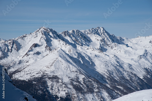 Fototapeta Naklejka Na Ścianę i Meble -  View of the mountains around the Tonale Pass from the Paradiso lodge during a winter sunny day. Tonale is a mountain pass between Lombardy and Trentino, near the Presena glacier