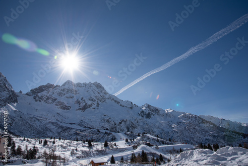 View of the mountains around the Tonale Pass during a winter sunny day. Tonale is a mountain pass between Lombardy and Trentino, near the Adamello park and the Presena glacier, in the north of Italy photo