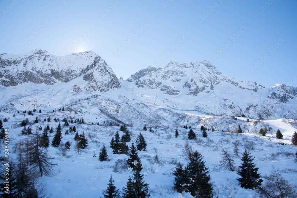 View of the mountains around the Tonale Pass during a winter sunny day. Tonale is a mountain pass between Lombardy and Trentino, near the Adamello park and the Presena glacier, in the north of Italy