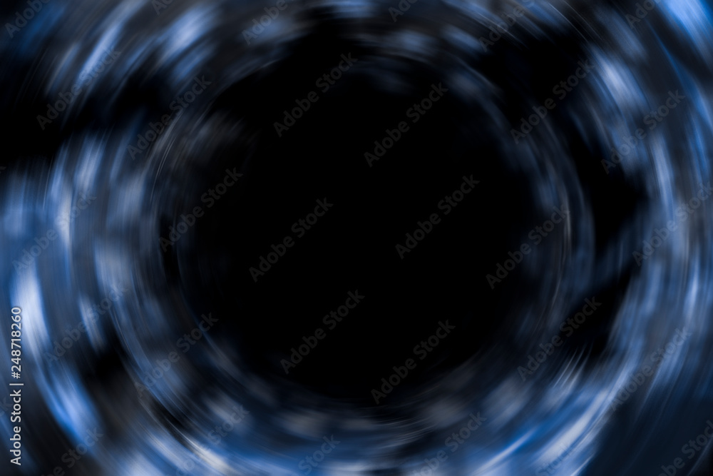 Blurred or defocused image of Dark blue cosmic vortex, portal background art, circle concept Blurred or defocused image of Dark blue cosmic vortex, portal background art, circle concept