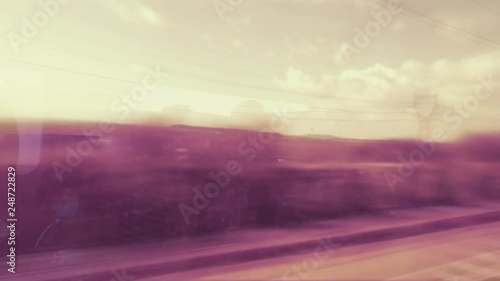 View from the train window over the nearby highway with trucks cars view from the high speed window of an ultra-fast train in France with destination Eurotunnel Channel tunnel London photo