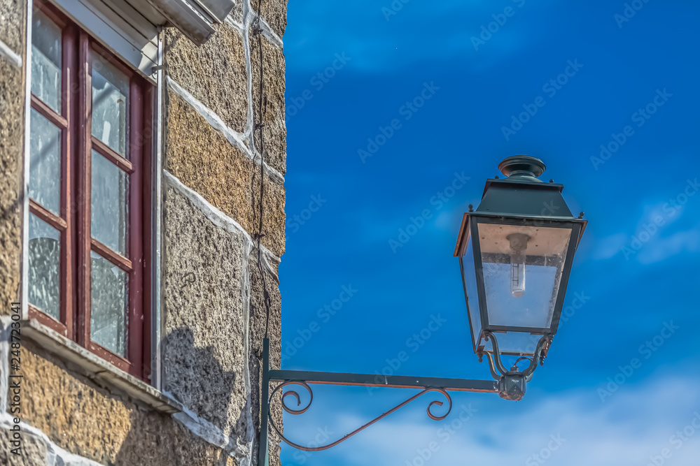 View of a public classic street lamp on exterior wall house
