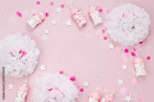 Frame made of Decorative Baby milk bottles with candy and paper decorations for Baby shower party. Flat lay, top view © igishevamaria