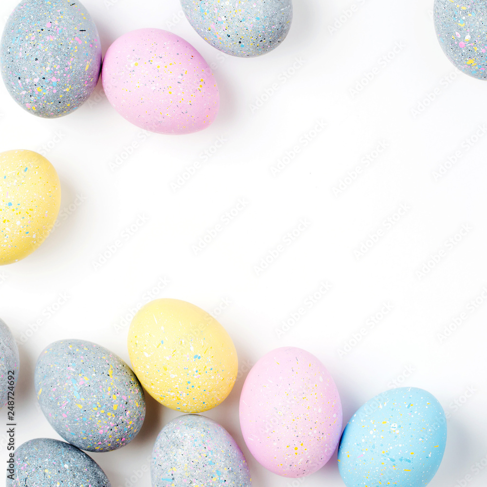 Stylish Frame of pale pink, blue and gray Easter eggs with copy space for text. Flat lay Stylish Frame of pale pink, blue and gray Easter eggs with copy space for text. Flat lay