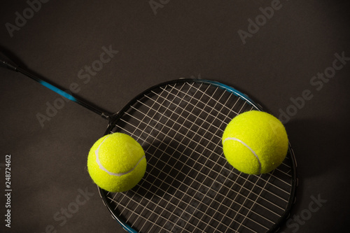 tennis ball and racket on dark