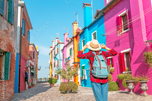 Happy asian traveler woman having fun on well known Burano island near Venice. Travel and vacation in Italy concept © EdNurg