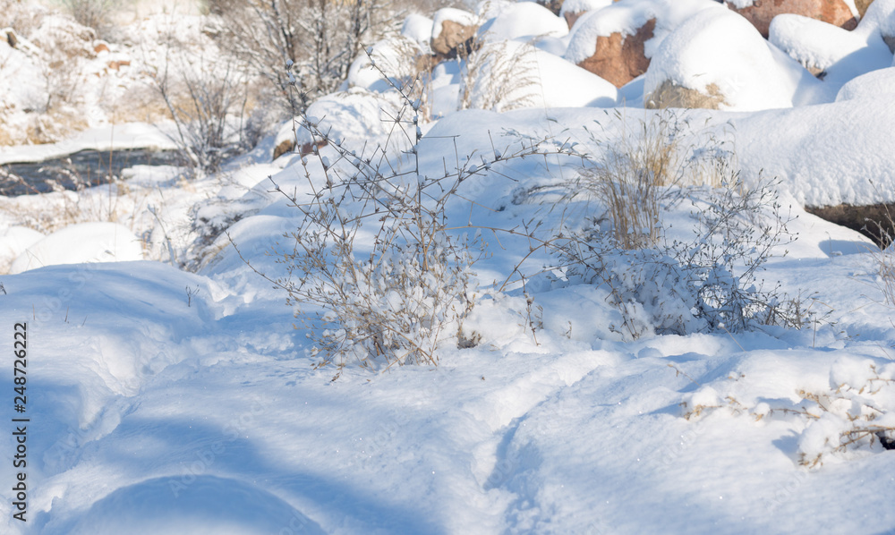 smooth movement of wild water in a river in winter with snow and ice on rocks and stones in beautiful nature smooth movement of wild water in a river in winter with snow and ice on rocks and stones in beautiful nature