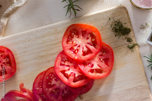 tomato slides on wooden board