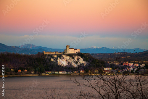 Obraz na plátne View of the Angera fortress at sunset
