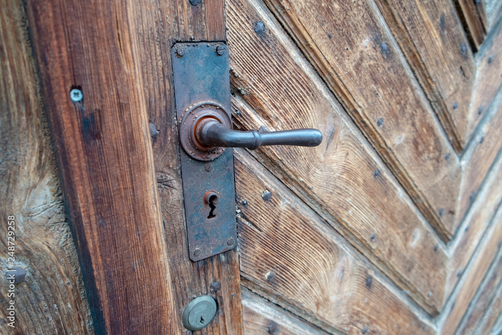 very wooden door with pattern very old worn out with iron door handle very wooden door with pattern very old worn out with iron door handle
