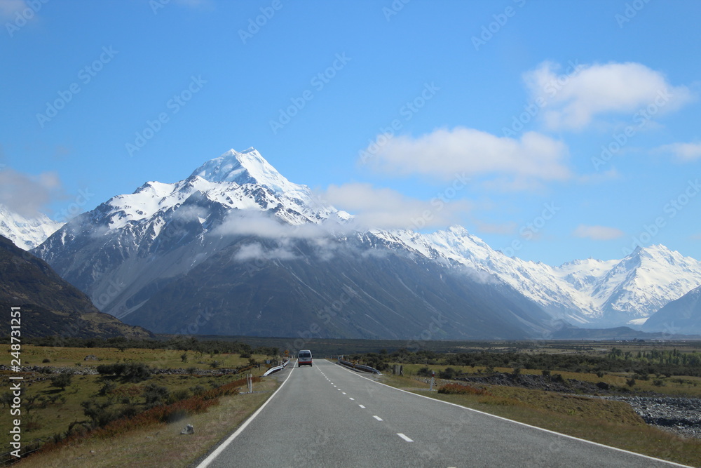 Empty Road with lonely car, Aoraki Mt. Cook, New Zealand, South Island Empty Road with lonely car, Aoraki Mt. Cook, New Zealand, South Island