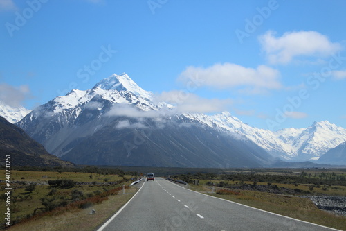 Empty Road with lonely car, Aoraki Mt. Cook, New Zealand, South Island