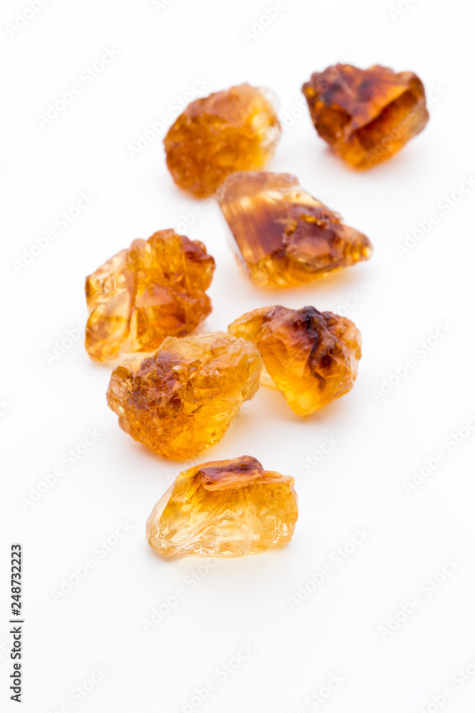 Brown caramelized sugar on white background. Brown caramelized sugar on white background.