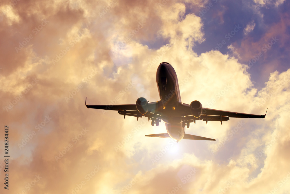 Evening sky with razravynnymi beautiful clouds of warm colors and airplane approaching the landing. Evening sky with razravynnymi beautiful clouds of warm colors and airplane approaching the landing.