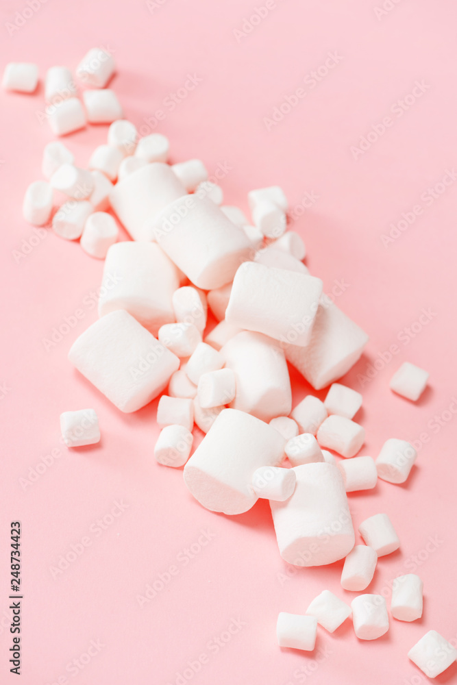 Various white marshmallows on the pink background Various white marshmallows on the pink background
