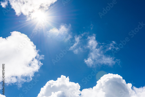 Blue sky with clouds and sunlights