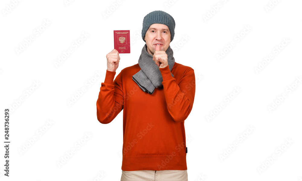 The Caucasian man with the international passport of the Russian Federation in warm clothes. The fist with bulged big and a little finger at a mouth, gesture - to drink, get drunk