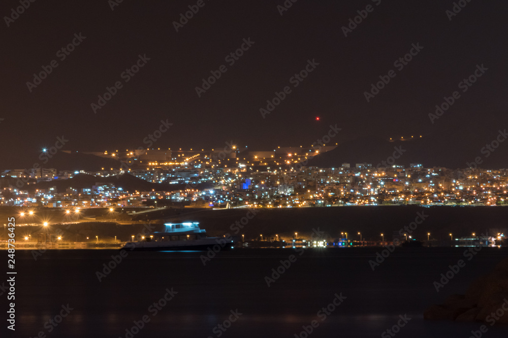 View of city light of Eilat in Israel from Aqaba in Jordan at night.