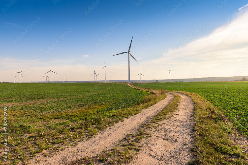 Windmills for electric power production surrounded by agricultural fields in Polish country side. Pomerania, Poland.