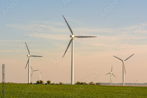 Windmills for electric power production surrounded by agricultural fields in Polish country side. Pomerania, Poland.