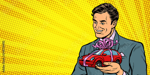 Businessman gives a gift, selling cars
