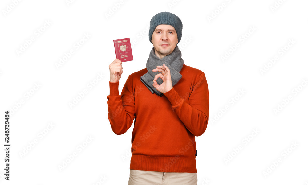 The Caucasian man with the international passport of the Russian Federation in warm clothes. Gesture OK, everything is good The Caucasian man with the international passport of the Russian Federation in warm clothes. Gesture OK, everything is good