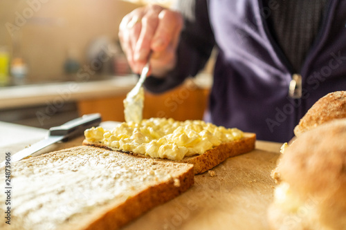 Woman making egg and onion sandwiches