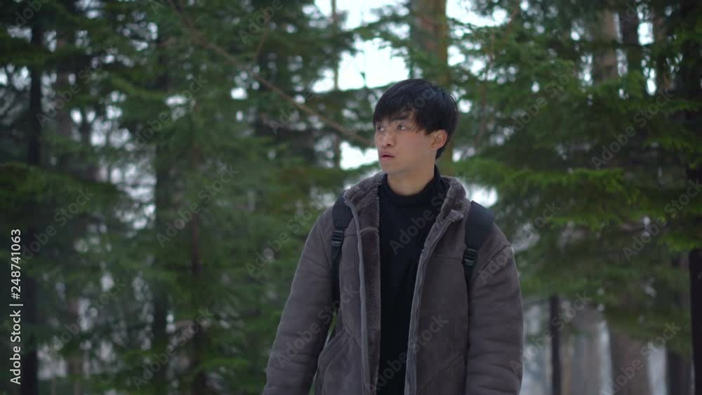 Lost Young Japanese Man Walking Around Aimlessly Alone in Forest During Winter Lost Young Japanese Man Walking Around Aimlessly Alone in Forest During Winter