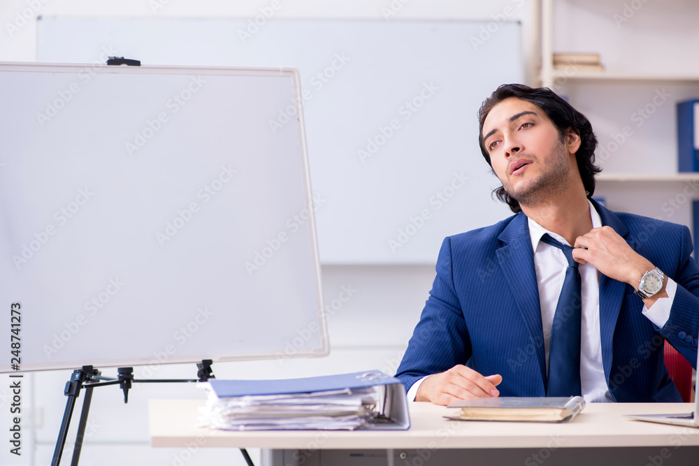 Young handsome businessman working in the office Young handsome businessman working in the office