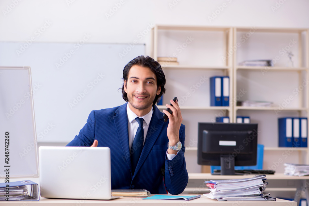 Young handsome businessman working in the office Young handsome businessman working in the office