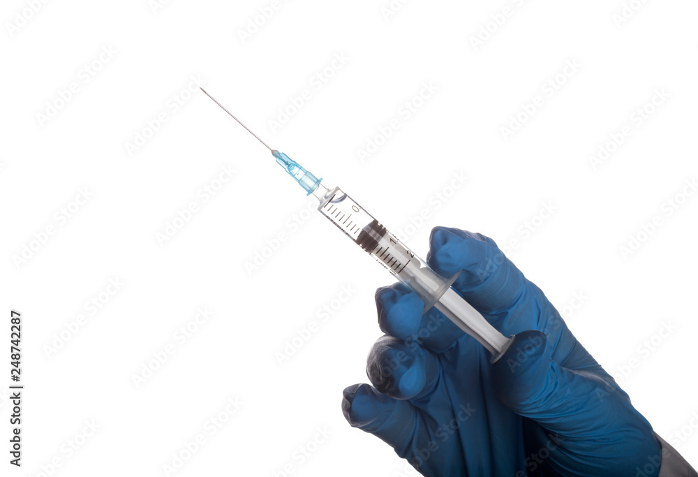 Doctor holding a syringe with an injection solution Doctor holding a syringe with an injection solution