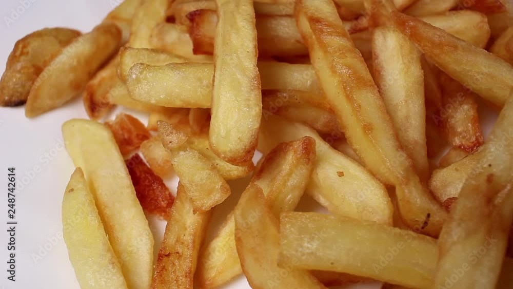 French fries fried potato slices food closeup texture pattern seamless looping rotating video footage hd resolution. French fries fried potato slices food closeup texture pattern seamless looping rotating video footage hd resolution.