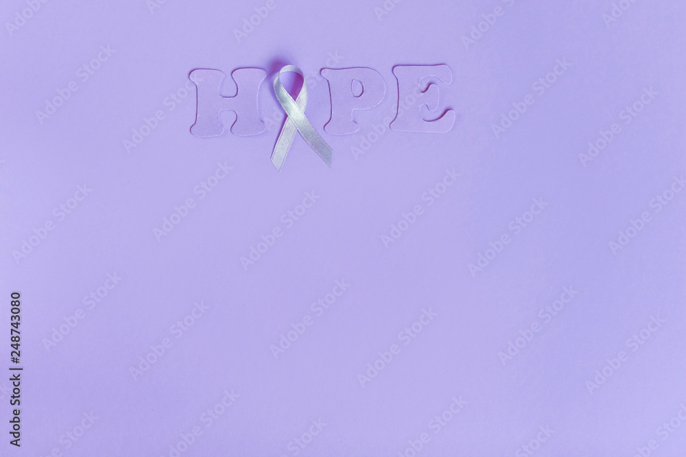 Lilac ribbon with word Hope on lilac background Lilac ribbon with word Hope on lilac background