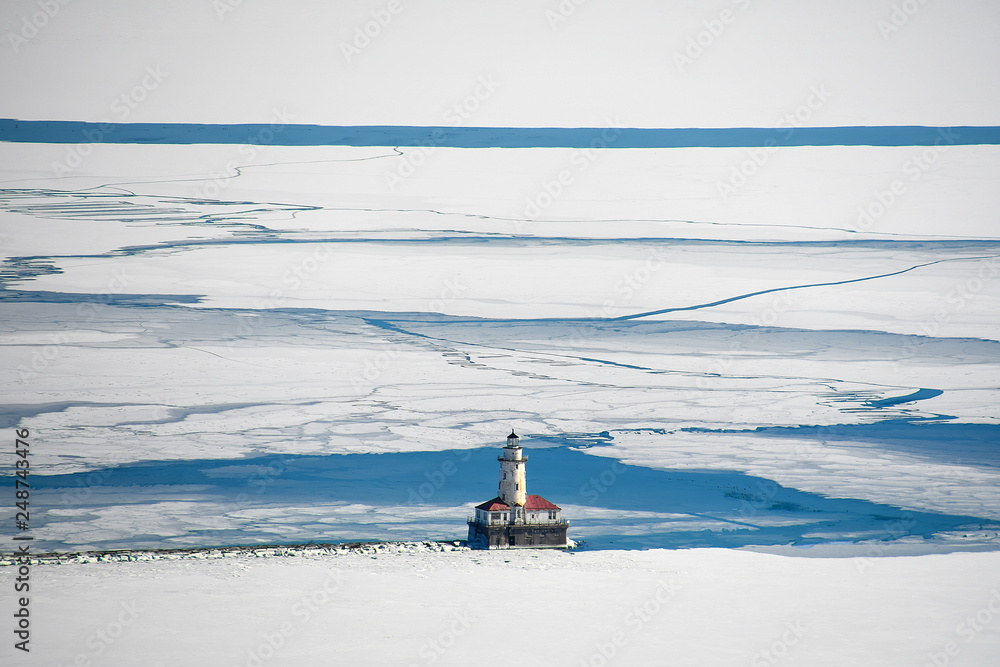 aerial view of Chicago lighthouse on Lake Michigan in ice and snow