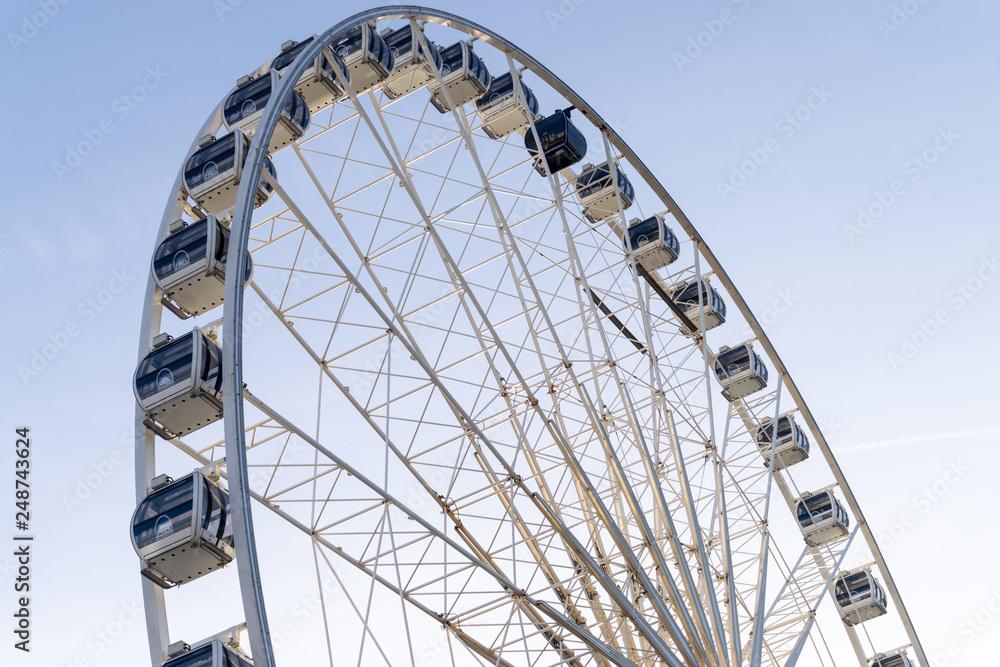 Closeup or ferris wheel of Liverpool Merseyside United Kingdom UK on a background of blue sky Closeup or ferris wheel of Liverpool Merseyside United Kingdom UK on a background of blue sky