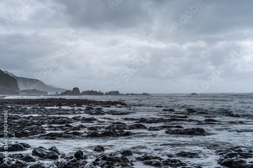 great rocks on the beach of New Zealand, amazing rocks on the beach, rock texture background on the beach, New Zealand coastline with foggy weather 