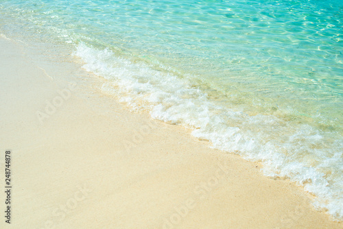 Fototapeta Naklejka Na Ścianę i Meble -  Soft wave of blue ocean on sandy beach. Background.