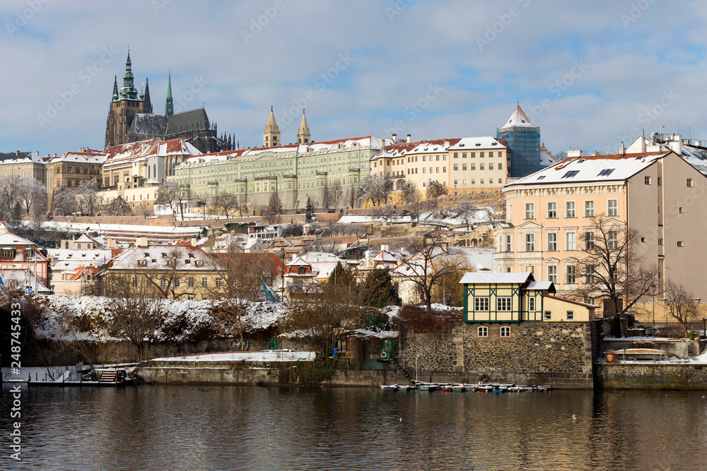 Snowy Prague Lesser Town with Prague Castle above River Vltava in the sunny Day, Czech republic