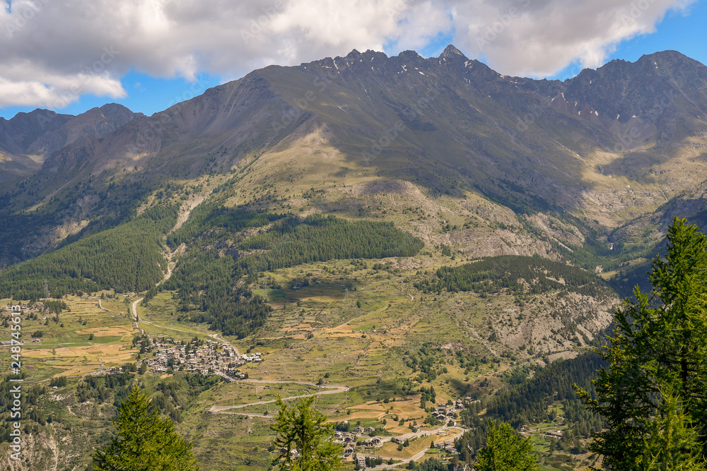 Elevated view of a mountain range with forests and boroughs in the Italian Alps, Cogne, Aosta Valley, Italy