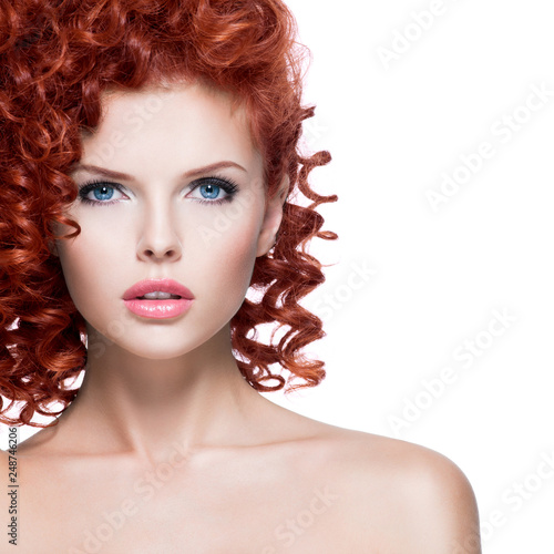 Beautiful young woman with red curly hair.