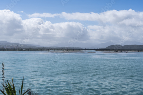 long bridge in New Zlong bridge in New Zealand with blue sky background und the ocean in the foregroundealand with blue sky background und the ocean in the foreground © FitchGallery