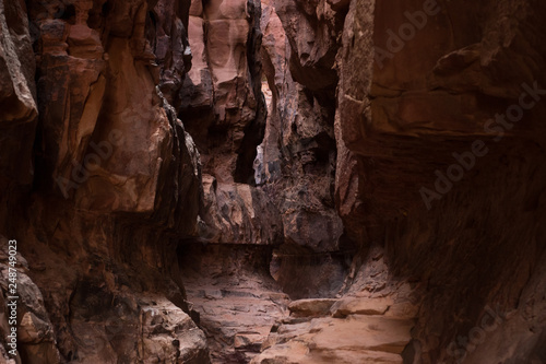 abstract soft focus yellow red and brown cave and steep rocks wall narrow path way