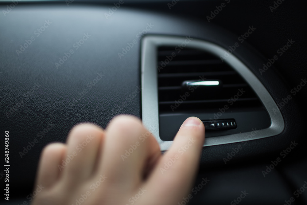 hand of man adjust heating on car. hand of man adjust heating on car.